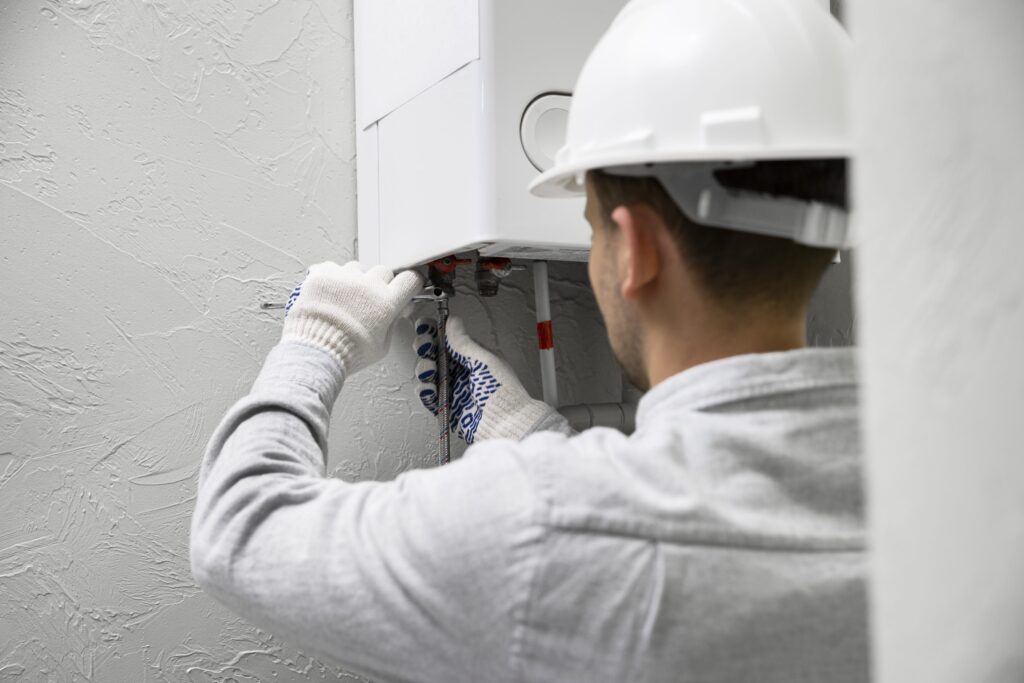 worker-repairing-water-heater-min